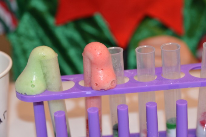 test tubes with red and green fizzy foam pouring out