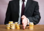 A businessman dividing a percentage of profit, assets, wealth or wages for investment