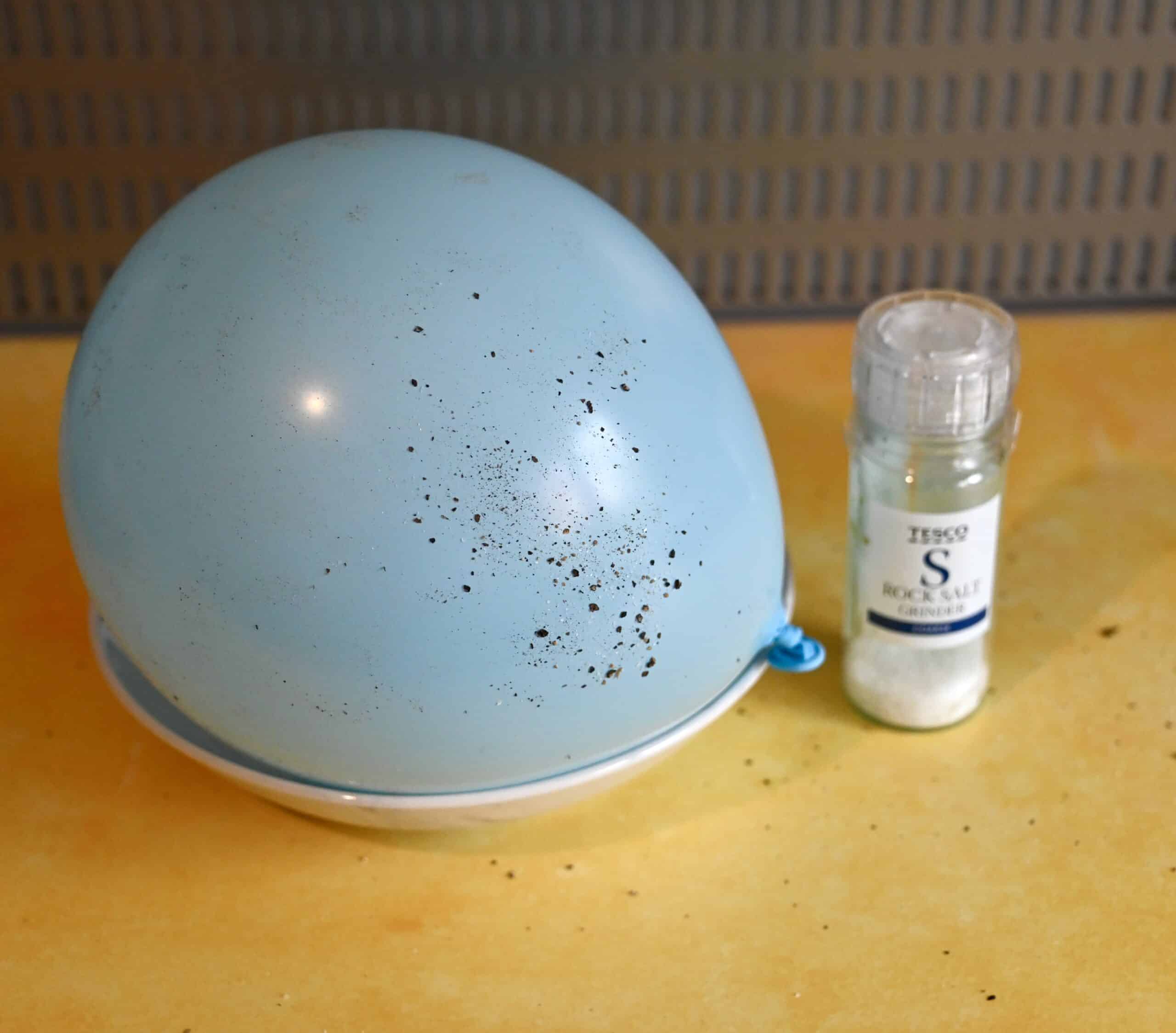 Ballon covered in pepper from a separating salt and pepper science activity